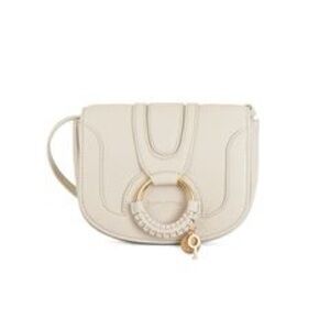 SEE BY CHLOE mini hana leather crossbody bag in off-white/cream color.